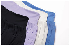 Conjunto Fitness com Cropped Gola Polo e Saia Shorts Plissada
